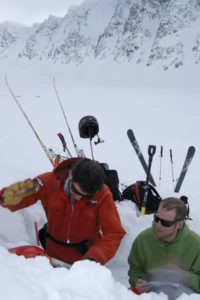 Nate Greenberg and Lorenzo Worster look at the snowpack.
